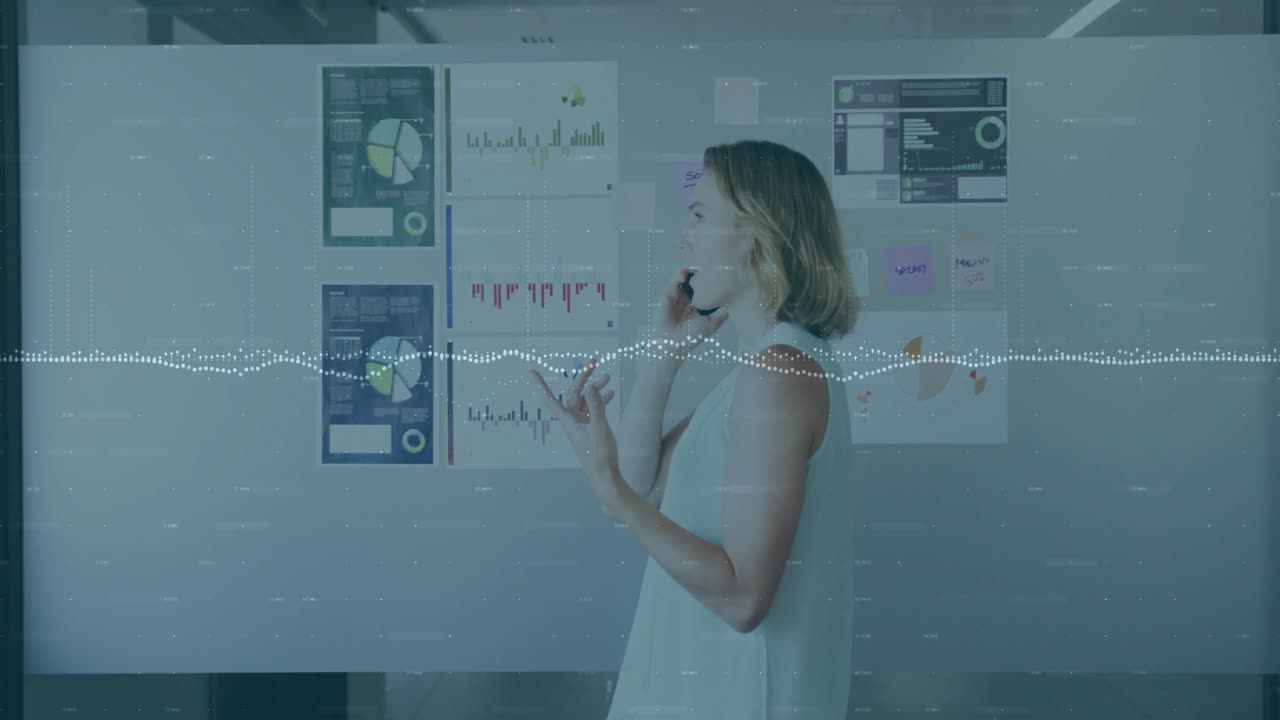Office professional surveying data and initiating business call animating trend visuals for insight