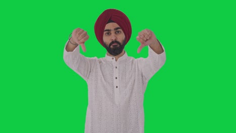 Disappointed-Sikh-Indian-man-showing-thumbs-down-Green-screen