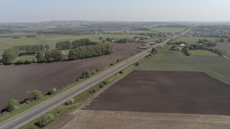 drone aerial view dolly left above british a580 east lancs highway in rural agricultural countryside
