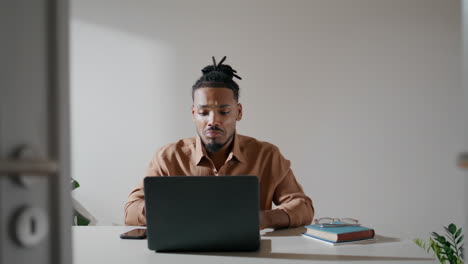 Successful-freelancer-video-chatting-home.-Man-gesturing-hands-at-virtual-call