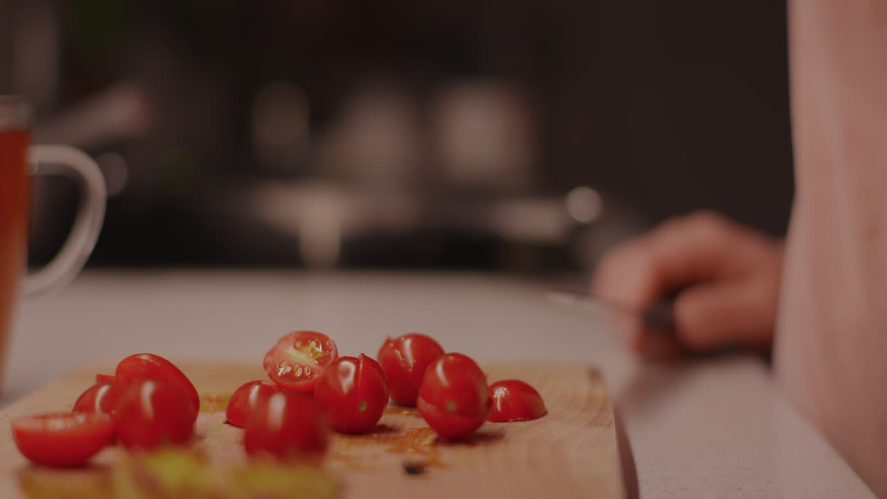 Preparing cherry tomatoes on a cutting board