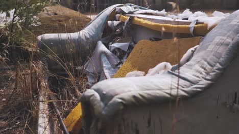 old trashed sofa dumped in nature