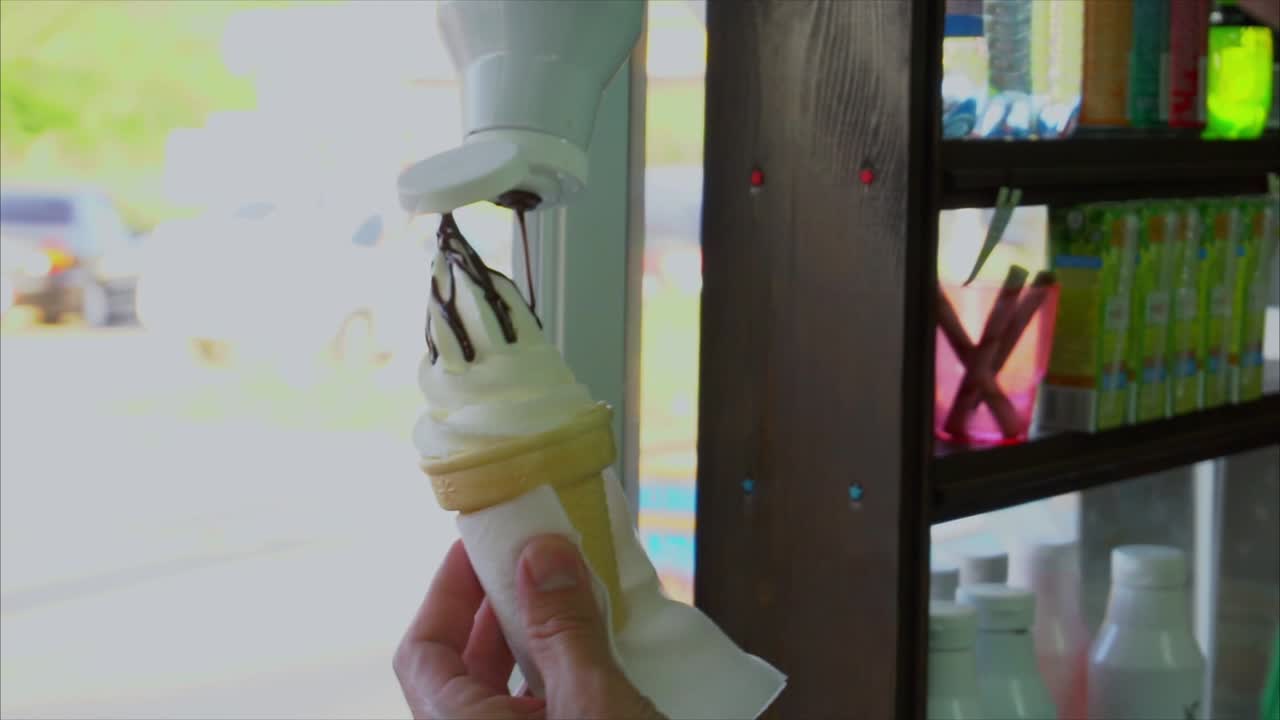 Hand-held Ice cream cone with chocolate topping