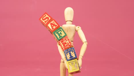 figurine holding alphabet toy block