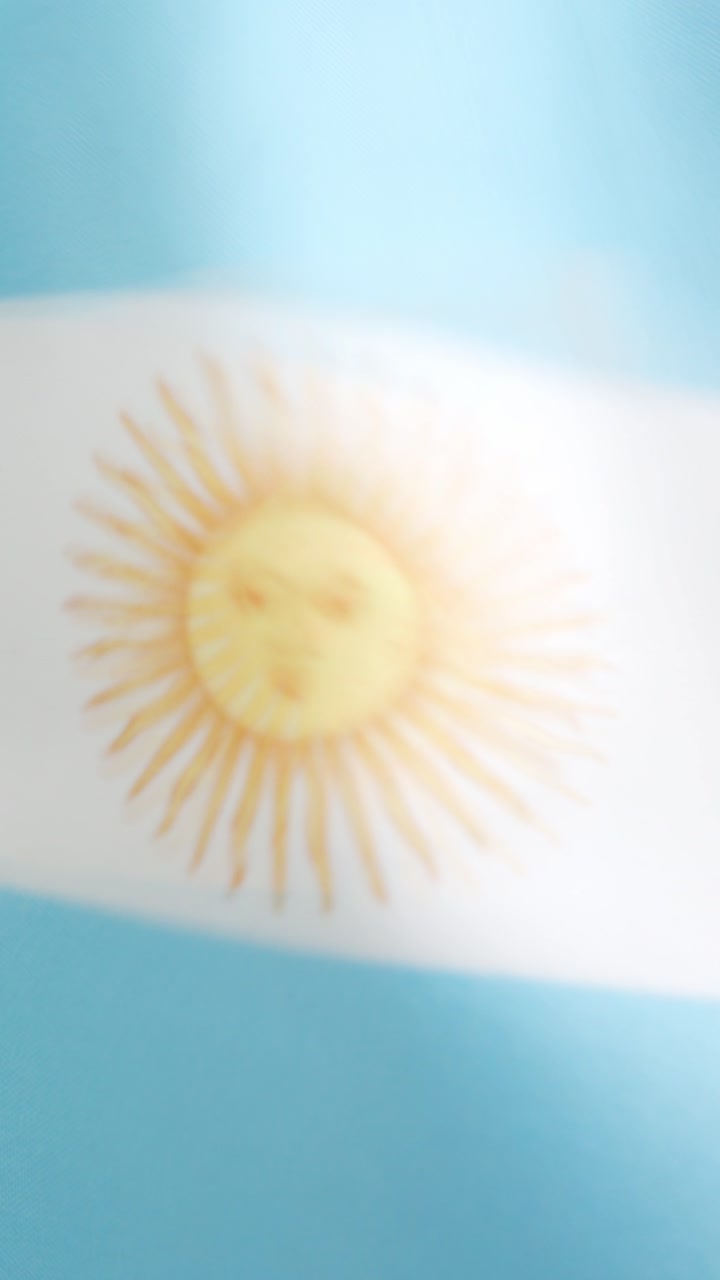 Vertical video of argentine national flag waving by the wind
