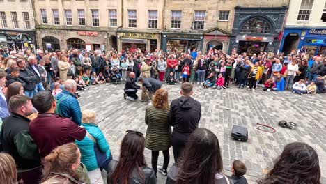 crowd watches performers in lively street show