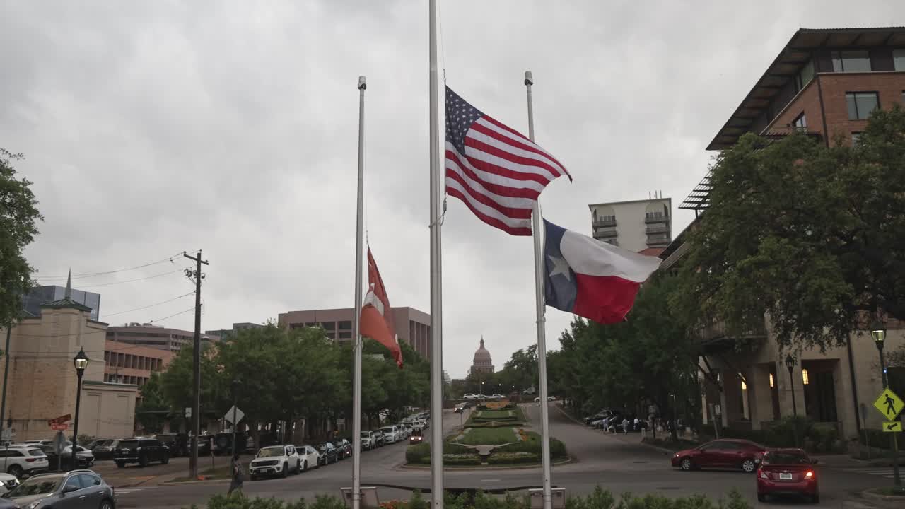 bandera estadounidense, bandera del estado de texas y bandera de la universidad de texas volando en austin, texas con video estable