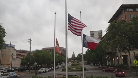 American-flag,-Texas-state-flag-and-University-of-Texas-flag-flying-in-Austin,-Texas-with-stable-video