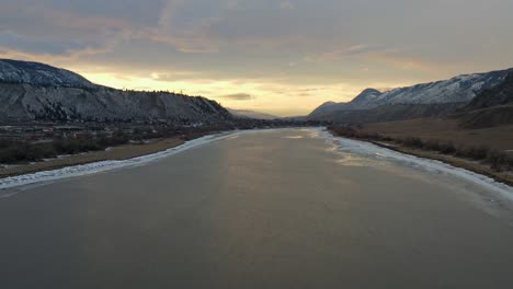 awe-inspiring sunset reflects on snow-laced thompson river