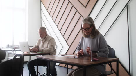 adult students using devices in classroom