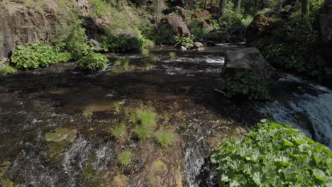 Retreating-aerial-reveals-McCloud-Falls-in-bright-dappled-sunlight