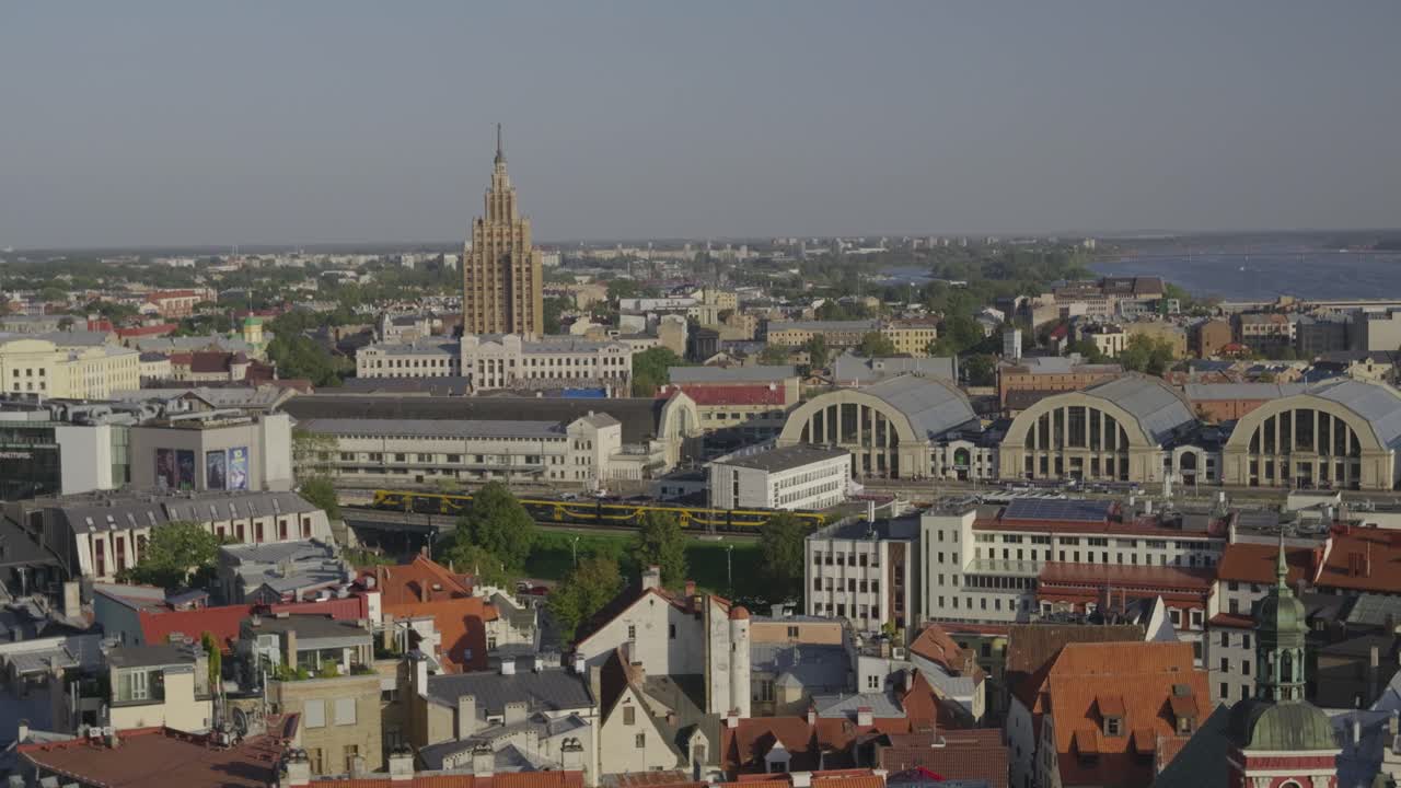 Panorama over Riga City with central market hall and train passing through