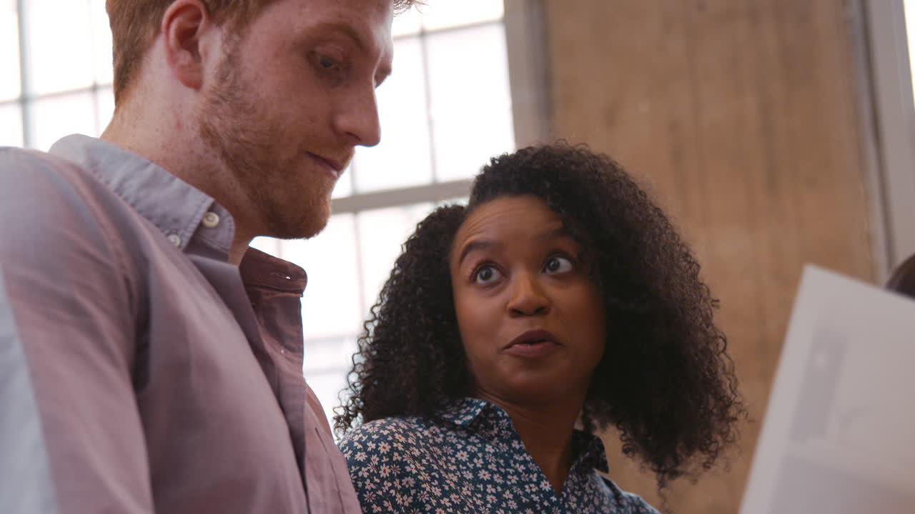 dos jóvenes creativos intercambiando ideas en el trabajo, de cerca