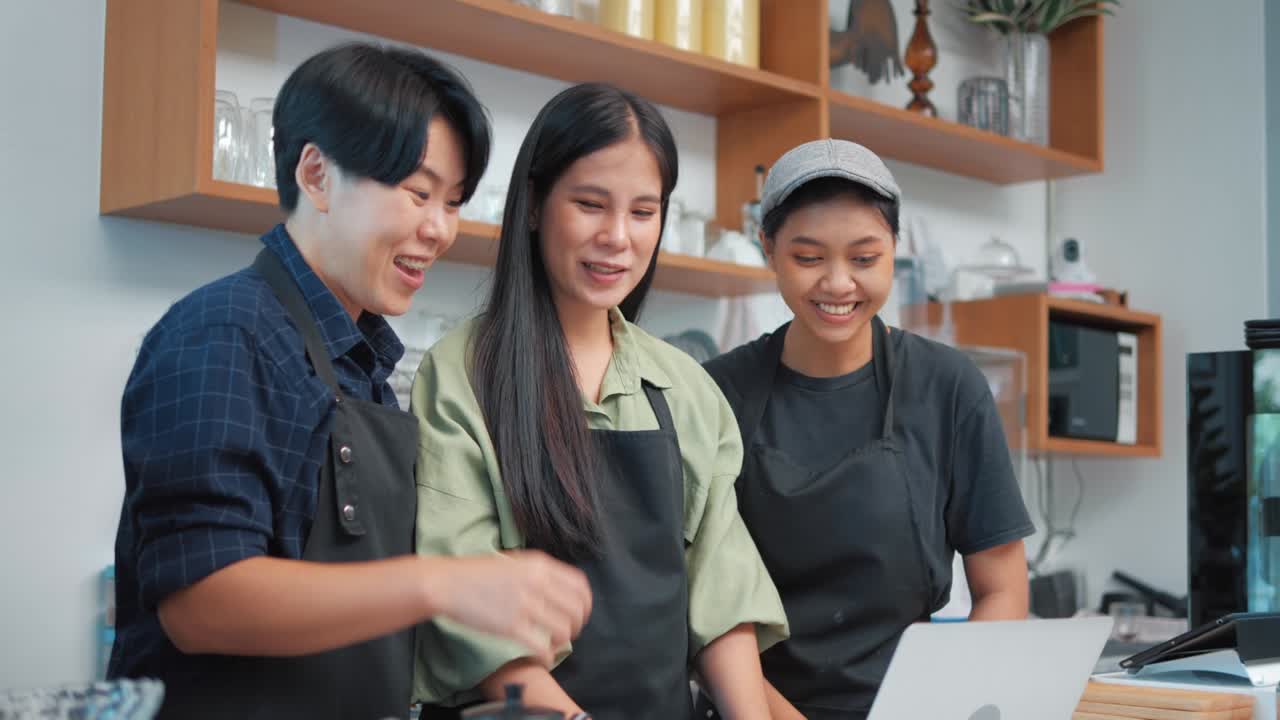 Group of LGBTQ young barista owner excited celebration success sign working. Small businesses starting. Small Business Owner Success concept.