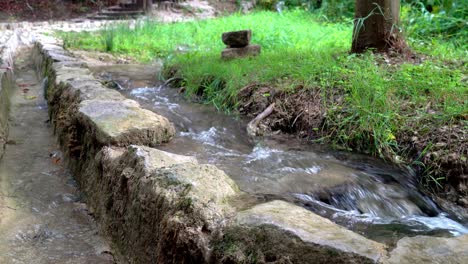 Agua-Que-Fluye-Junto-A-Un-Muro-De-Piedra-A-Lo-Largo-De-Una-Pasarela-En-El-Parque-Nacional-Krka-En-Croacia