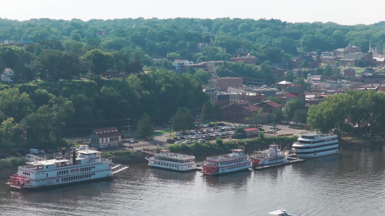 Aerial wide panning shot of historic paddlewheel riverboats on the St. Croix River in Stillwater, Minnesota. 4K