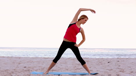 woman stretching on the beach