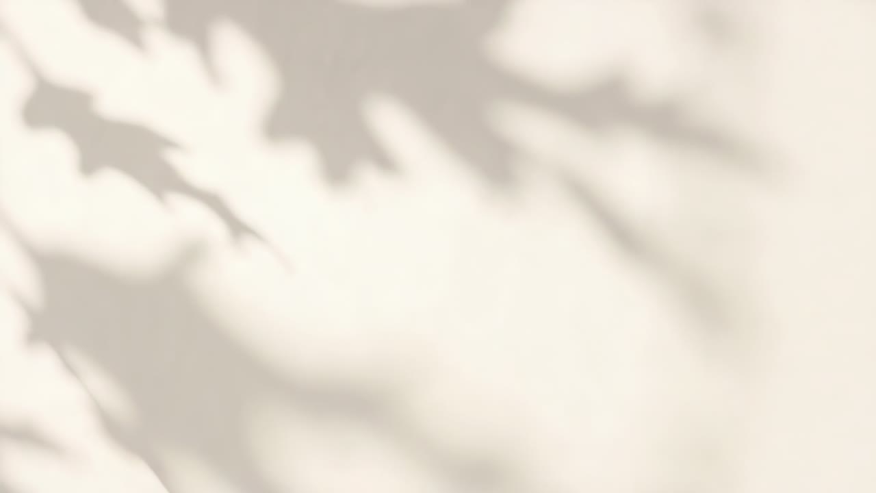 Shifting leaf shadows sweeping across pale vertical wall, sunlight angle and breeze causing motion