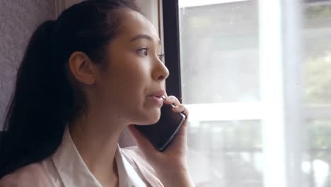 Businesswoman-using-phone-on-the-train