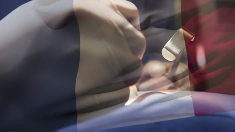 animation of flag of france waving over surgeons in operating theatre