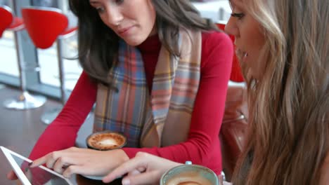 pretty friends enjoying coffee in cafe