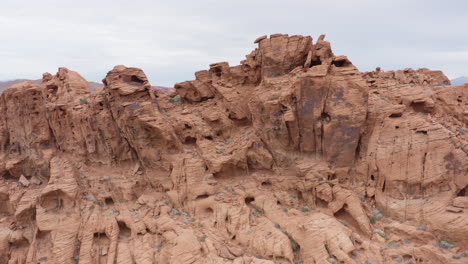 Cinematic-pullback-shot-of-red-sandstone-formation-resembling-landscape-on-Mars,-aerial-drone-shot