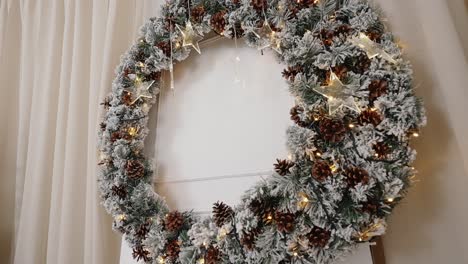 frosted pinecone wreath with golden stars