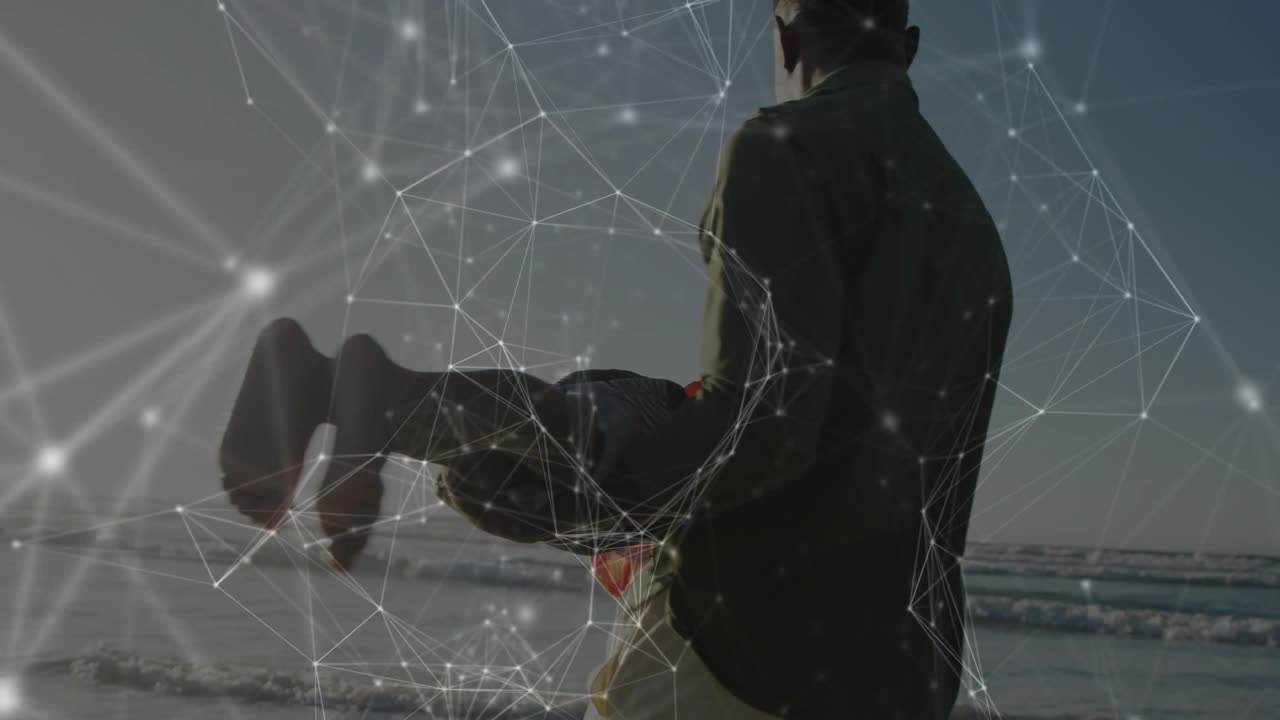 Father standing at shore holding son, mimicking flight swinging through surf under golden horizon
