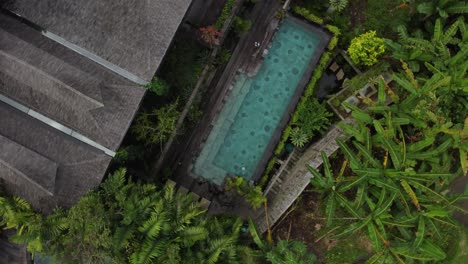 aerial: top down shot of beautiful pool in a bali mansion