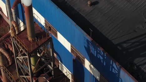 aerial view of industrial factory with smoke stack