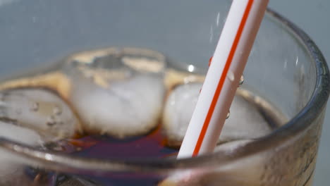 close up macro, refreshing drink is sipped through a straw