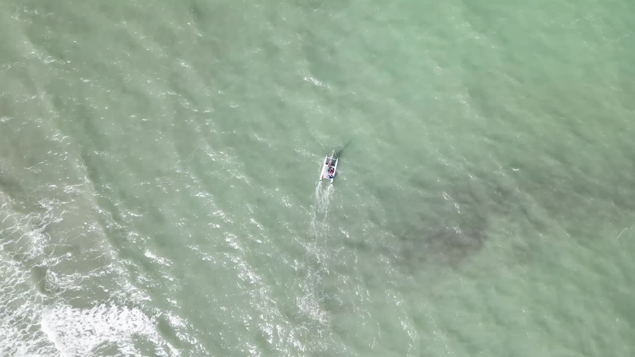 Drone flying over a sailing catamaran cruising across the sea. Perfect for nautical, travel, and scenic aerial content