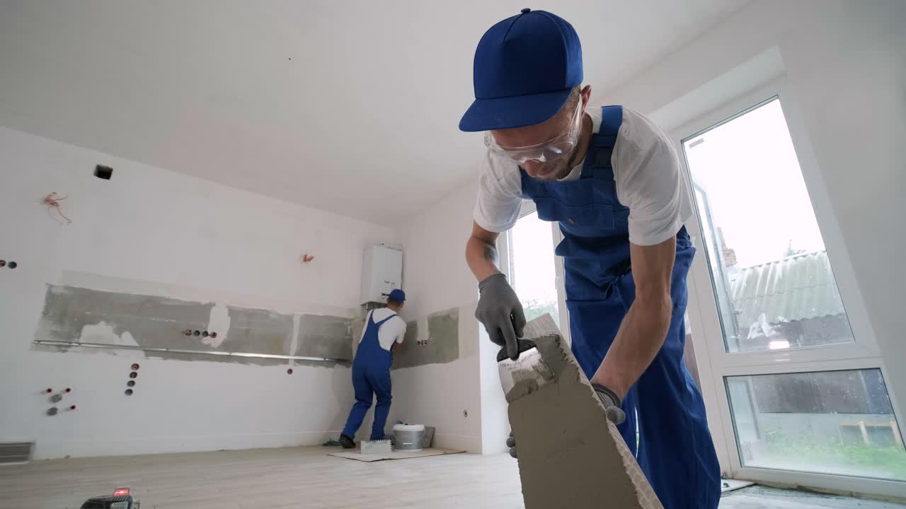 Installing ceramic floor tiles - measuring and cutting the pieces. Construction, renovation, repair apartment. Cuts tile. Tile cutting