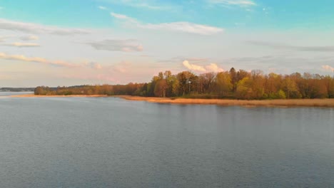 approaching jugla lake shores riga at golden hour aerial