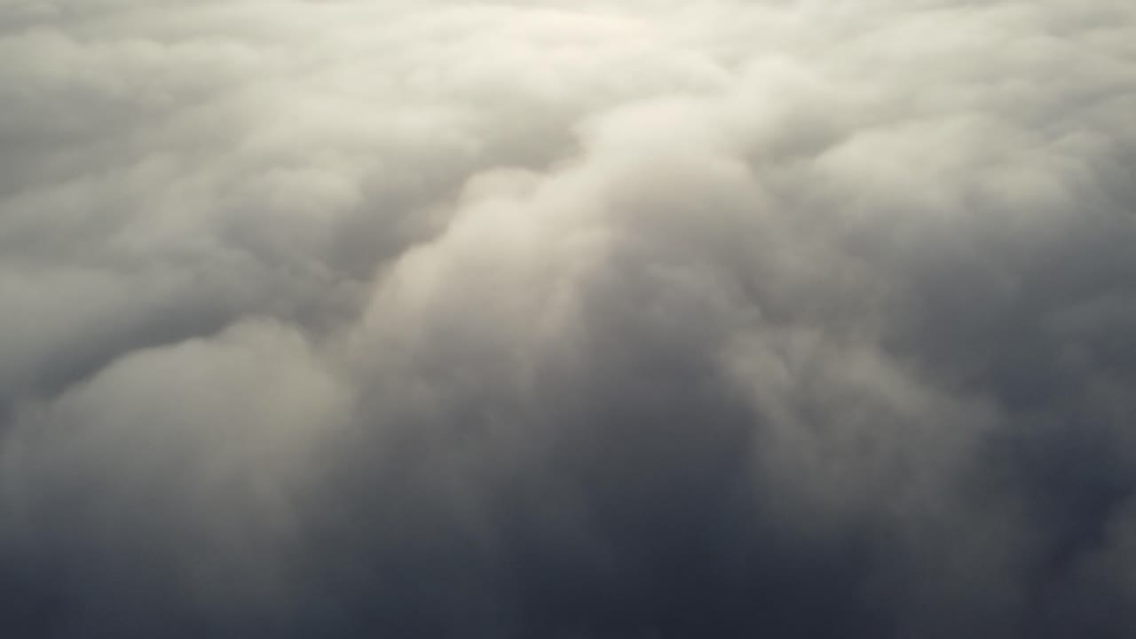 Aerial view over white clouds