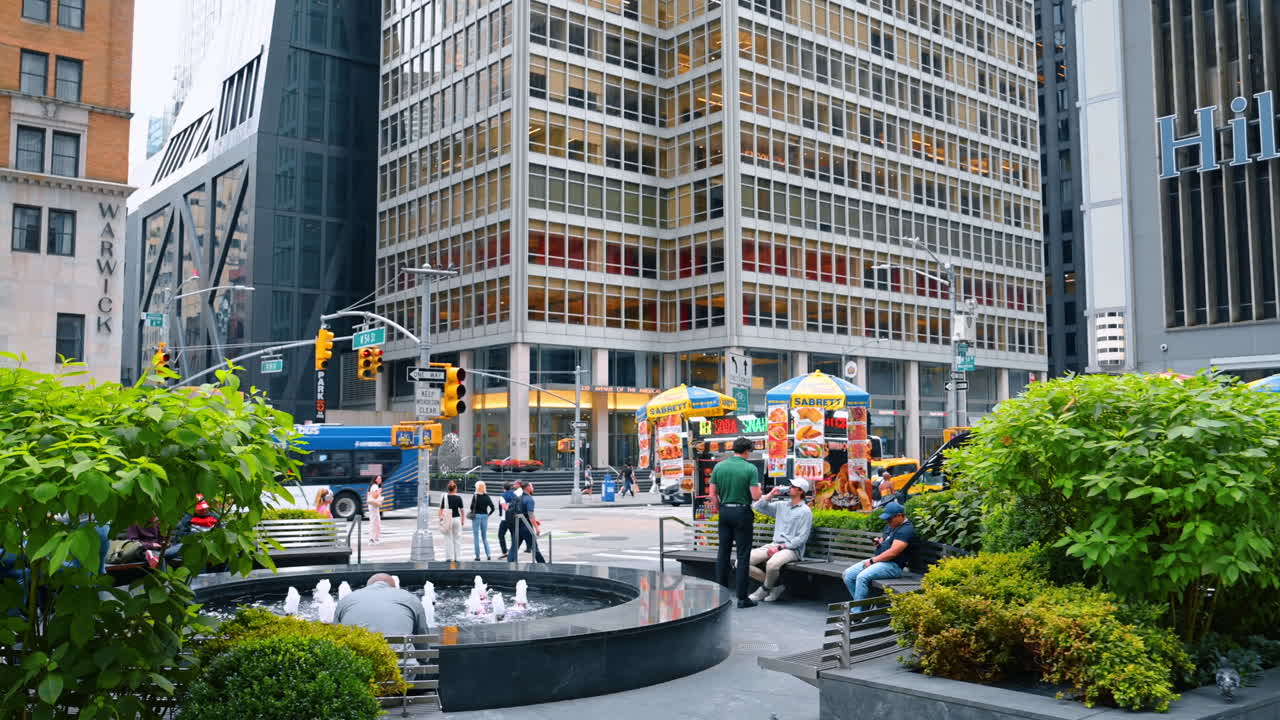 New York, USA, 1 August 2025: Urban greenery in New York streets. Trees and greenery along the streets of New York with city buildings in the background