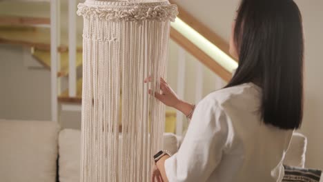 home hobby, knitting macrame. women's hands knit an ornament with thick threads.