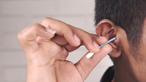 cleaning ear with cotton swab