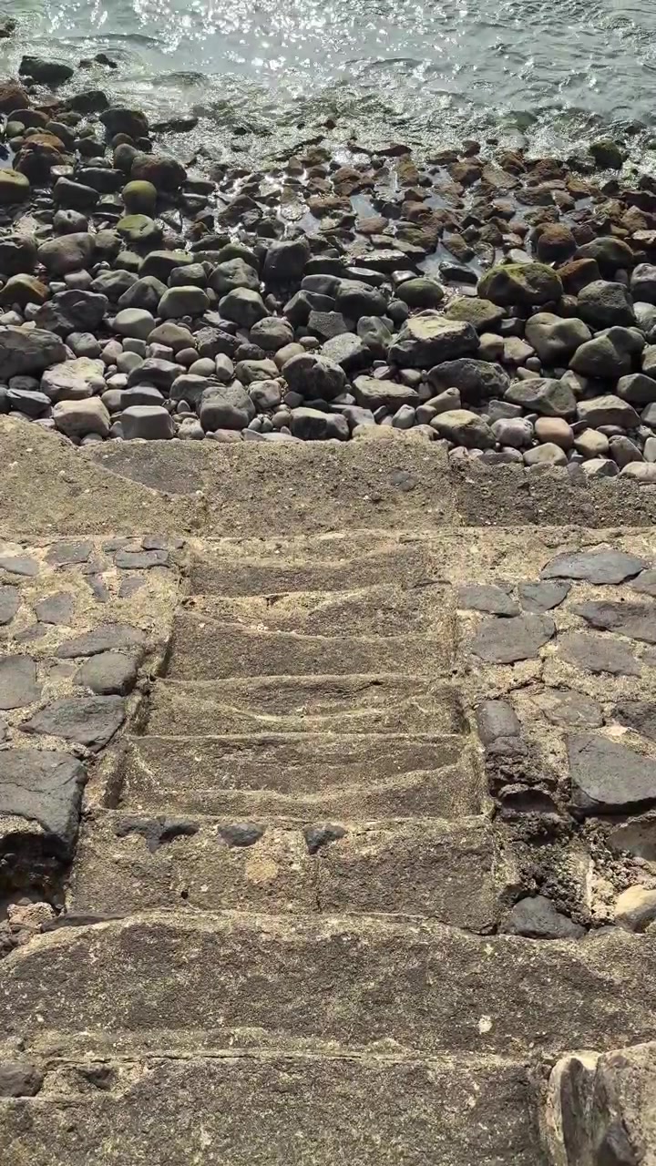 Stone Stairs Leading Down to a Rocky Beach Shoreline