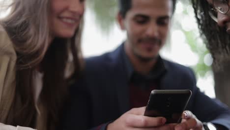 Man-and-woman-swiping-photos,-choosing.-Focus-on-hands-and-handy