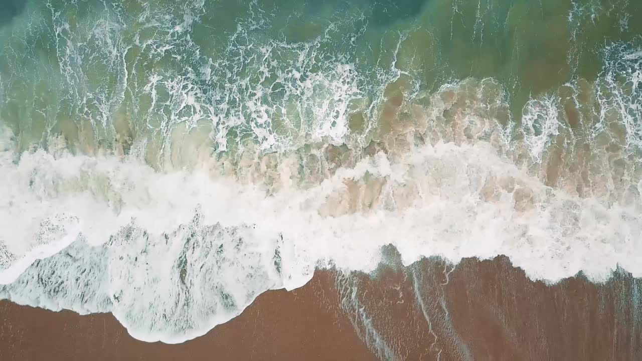 Aerial Footage of waves on sandy beach