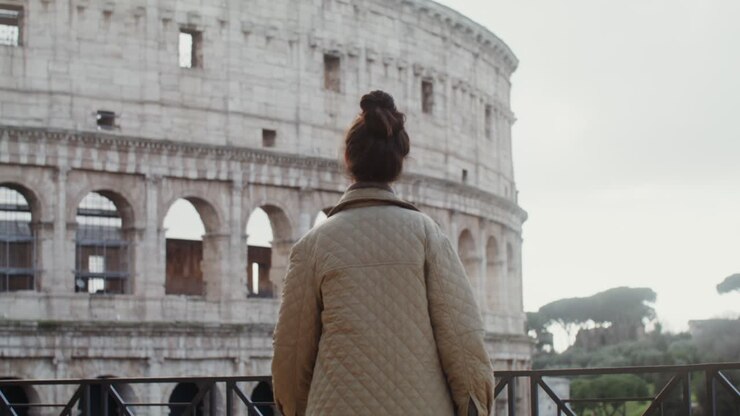 Woman admiring the Colosseum in Rome
