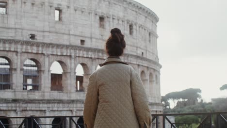 woman admiring the colosseum in rome