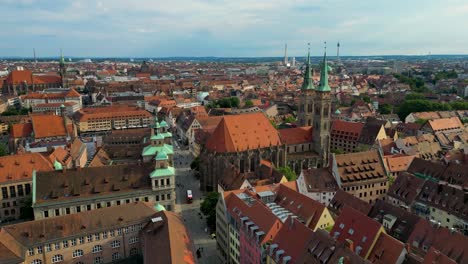4k aerial drone video of the copper-clad twin spiers on the beautiful sebalduskirche church in downtown nurnberg, germany