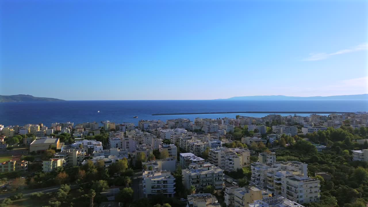Aerial panoramic, right pan high angle view of Messinian gulf, view from Kalamata city, during sunny day of autumn with clear blue sky 4K