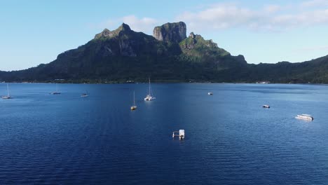 Flyover-tranquil-blue-bay-on-south-seas-Polynesian-Island-of-Bora-Bora