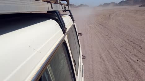 rear view of driving through rocky desert in egypt