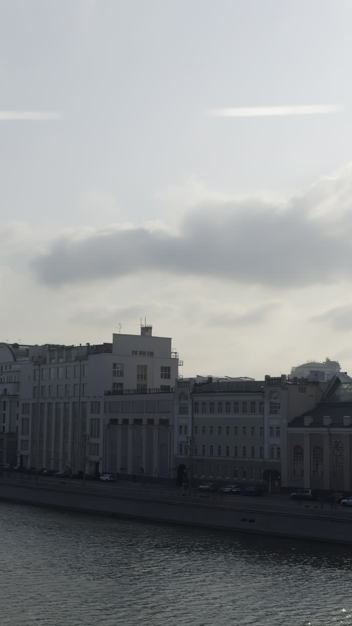 Cityscape view of a European city with buildings along a river on a cloudy day