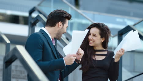 handsome business man and woman smiling outdoors