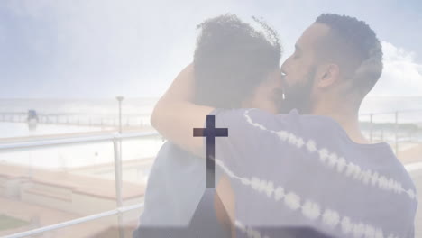 embracing couple at seaside with cross symbol and animation overlay